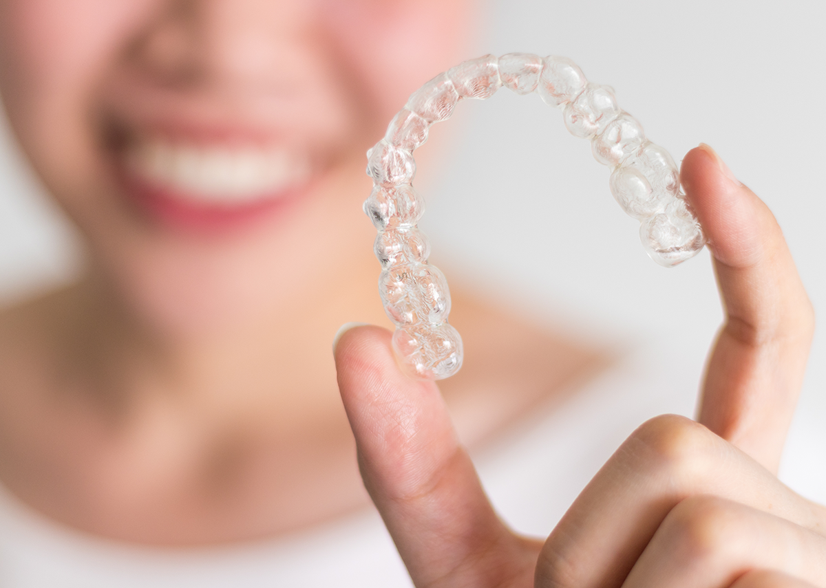 Bixby Dental Page Header Image | Person holding a clear dental aligner